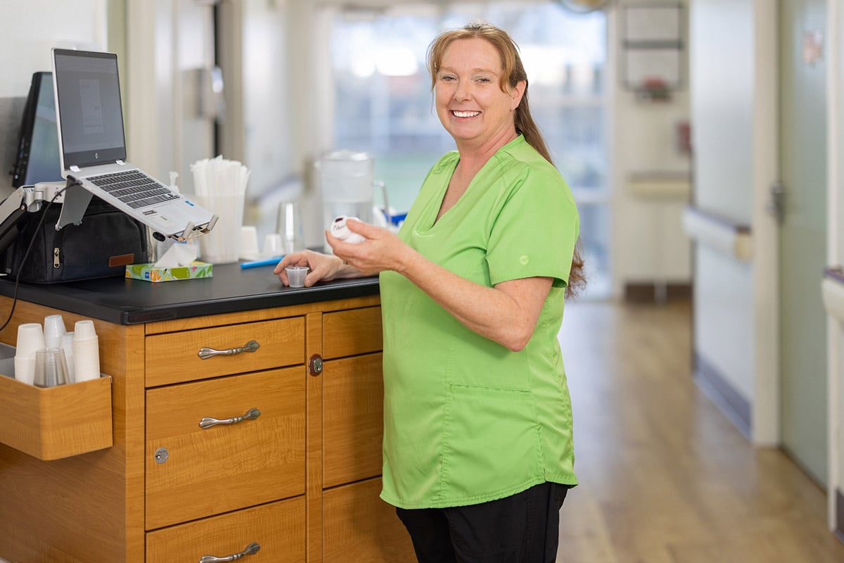 Nurse administering medicine at Orchard View Post Acute