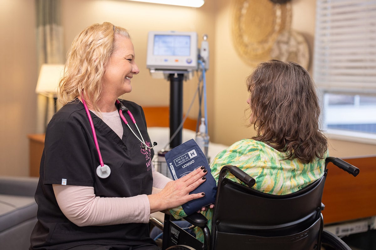 Nurse taking patient's blood pressure at Orchard View Post Acute